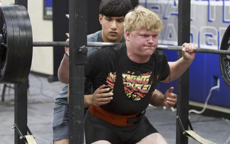 Brody Hilgenberg pushes up weight during the squat portion of the Badgers’ home powerlifting meet on Thursday. HUNTER KING | DISPATCH RECORD