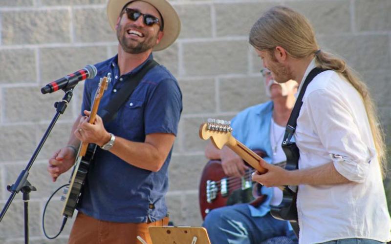 Cord Jackson, at right, performs a solo number while Zach Huckabee accompanies on guitar during the Tuesday night Hayloft Party. mason hines | dispatch record