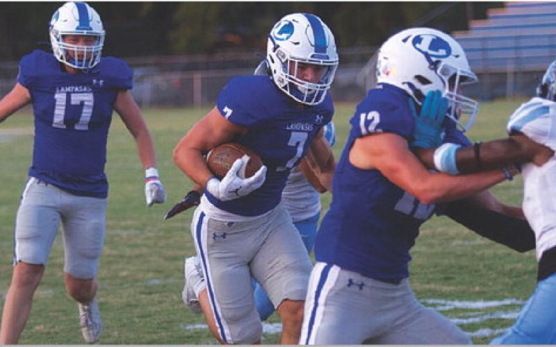 HUNTER KING | DISPATCH RECORD Jett Walker follows the block of Bryson Roberts in the first quarter of last Friday’s win.