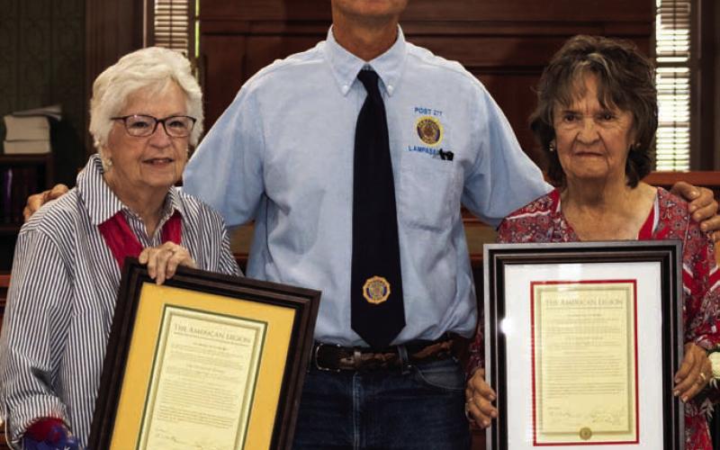 Post Commander Steve Cook is flanked by Carol Wright, left, and Dorothy Briggs with their commemorative resolutions recognizing the contributions their husbands made to the American Legion. The local post has been renamed in their memory. MARTIN RODRIGUEZ | COURTESY PHOTO