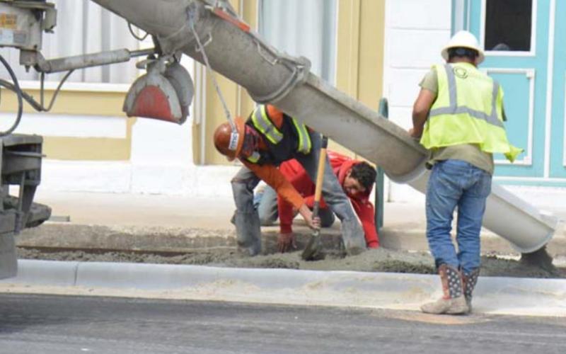Work crews place cement for the Third Street sidewalks last week. Drivers can now drive on the street, but the project is not entirely completed as of Thursday morning. MONIQUE BRAND | DISPATCH RECORD
