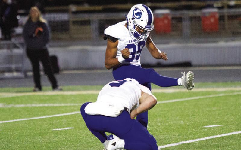 HUNTER KING | DISPATCH RECORD Zimri Vergara swings through an extra-point attempt during last week’s game.
