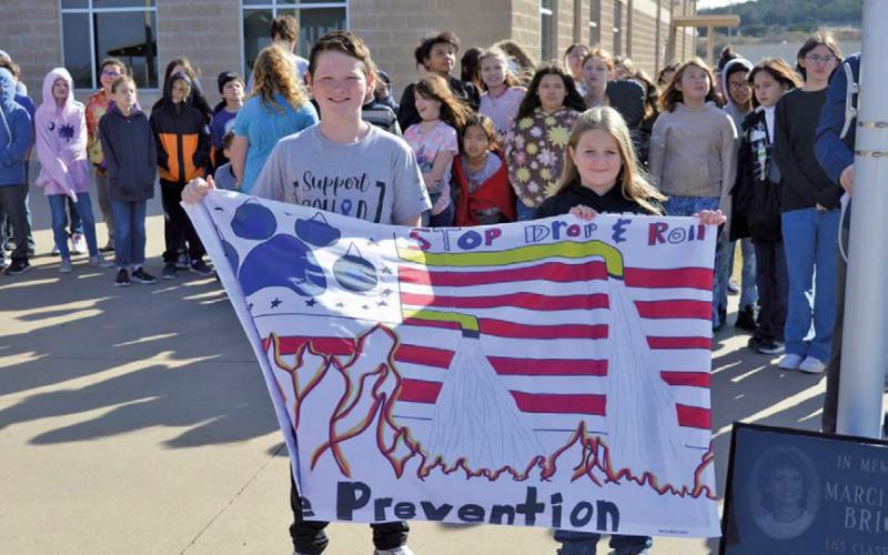 Erich Lent, Keely Riley and Evelyn Walker (not pictured) were responsible for the winning flag design at Taylor Creek Elementary School. erick mitchell | dispatch record