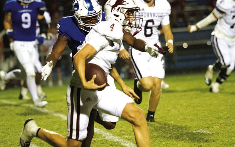 HUNTER KING | DISPATCH RECORD Trenton Hobbs chases down the Brownwood quarterback for a tackle for loss.