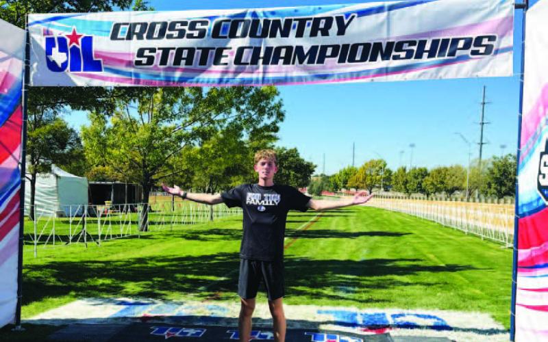 COURTESY PHOTO | KIM BURNSIDE John Keyes poses for a photo at the finish line of the state cross country meet.