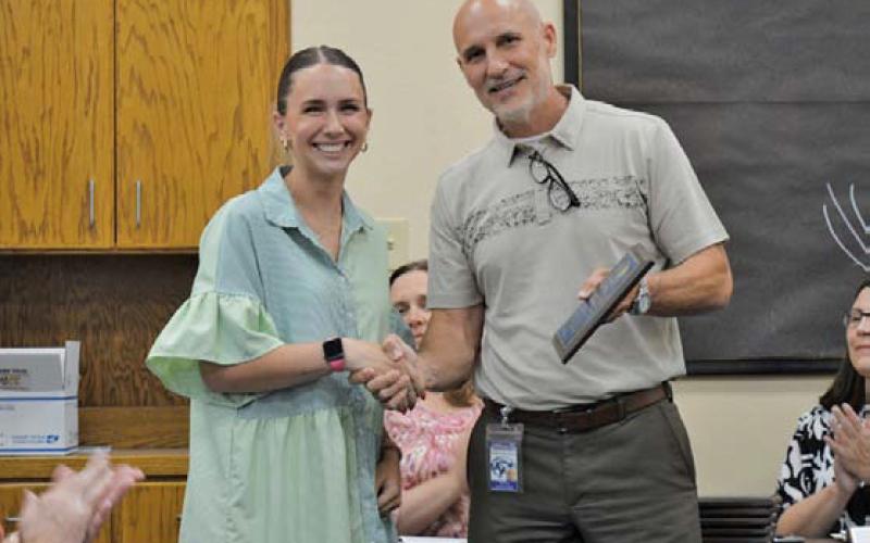Taylor Creek Elementary School teacher of the year Lauren Robinson receives her plaque of achievement from Assistant Superintendent Dana Holcomb. Lampasas ISD’s Teachers of the Year for 2025 were recognized at Monday’s Board of Trustees regular meeting. ERICK MITCHELL | DISPATCH RECORD