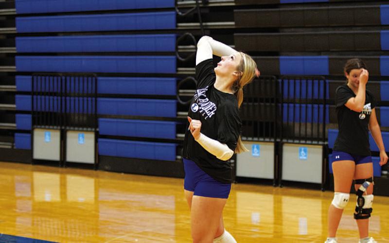 HUNTER KING | DISPATCH RECORD Meredith McBeth swings through a serve.