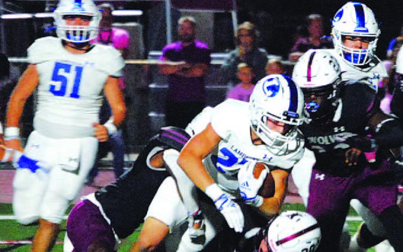 Jett Walker falls forward for extra yards on a run against Davenport last Friday. HUNTER KING | DISPATCH RECORD