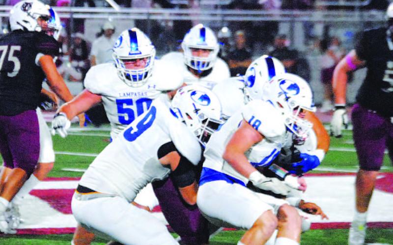 A host of Badgers are in on a tackle of the Davenport ball carrier. HUNTER KING | DISPATCH RECORD