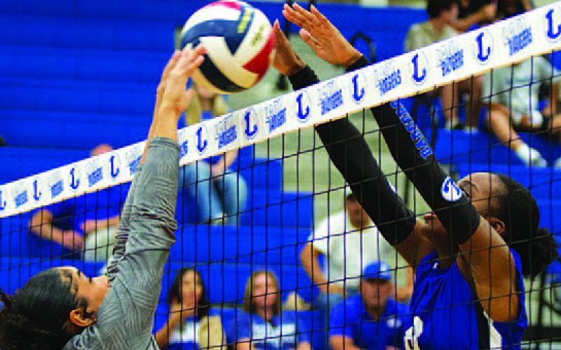 Angelina Davis leaps to challenge for a ball against Jarrell. HUNTER KING | DISPATCH RECORD