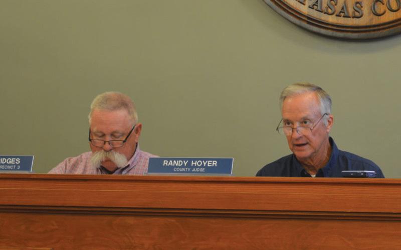 At left, Precinct 3 Commissioner Lewis Bridges looks on as County Judge Randy Hoyer speaks during the court’s regular meeting Aug. 12. erick mitchell | dispatch dispatch