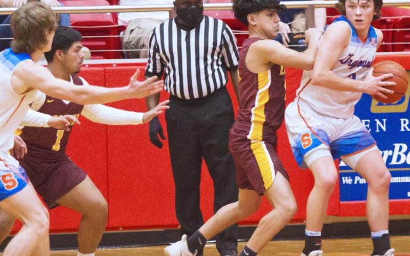 Lometa senior Damion Salinas (1) and sophomore Jeremiah Valenzuela (second from right) defend against Slidell in Tuesday’s fourth-round playoff game at Glen Rose. JEFF LOWE | DISPATCH RECORD