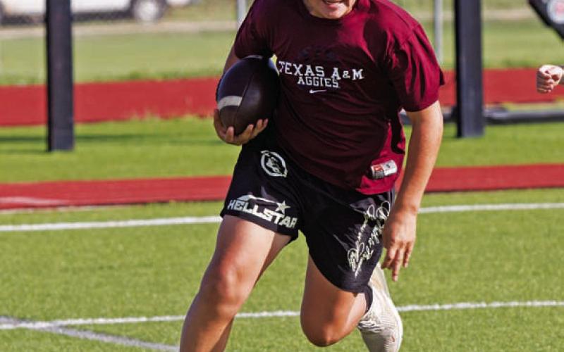 Brylan Chevez turns up field during a runningback drill. ERICK MITCHELL | DISPATCH RECORD