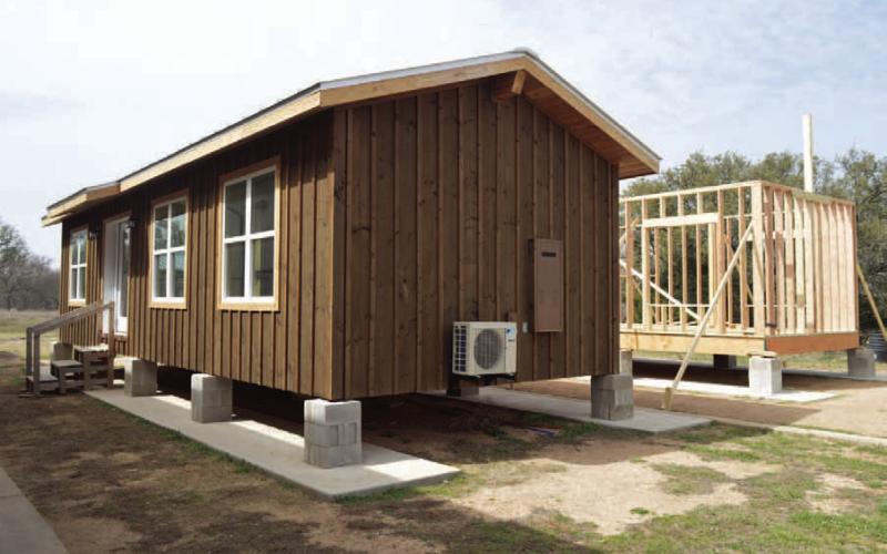 ERICK MITCHELL | DISPATCH RECORD Students in the high school’s construction program have worked with Creating Badger Builders mentors to complete a 560-square-foot tiny home. A second tiny home project, shown at back right, is in the intial construction stages.