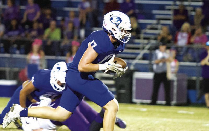 HUNTER KING | DISPATCH RECORD Preston Isom runs up the middle of the field.
