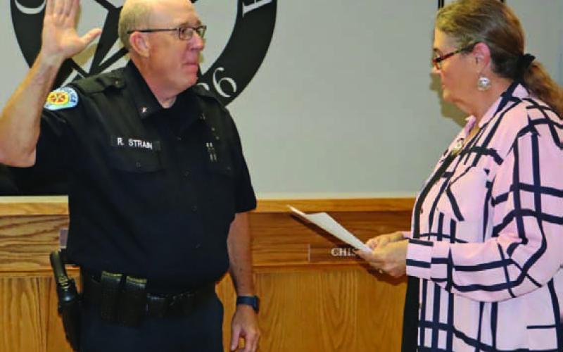 Lometa Municipal Judge Sharon Watson swears in new Police Chief Ronald Strain during last week’s Lometa City Council meeting at City Hall. CHERI JAY-WIENECKE | DISPATCH RECORD