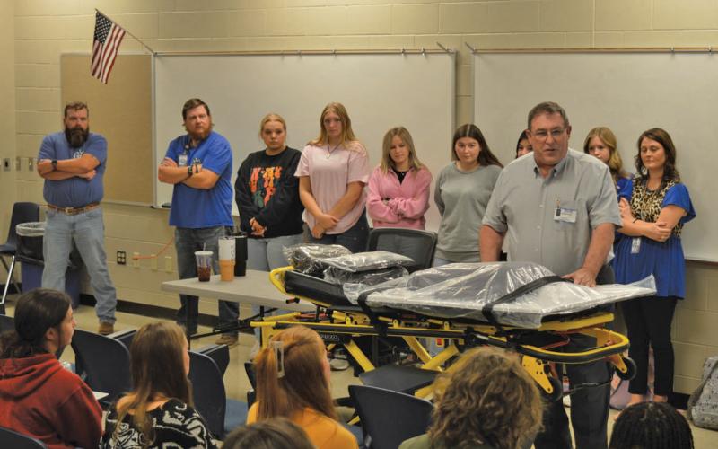 Creating Badger Builders President Herb Pearce speaks to students after the non-profit organization donated a new ECG simulator and stretcher on Tuesday for various CTE programs. erick mitchell | dispatch record