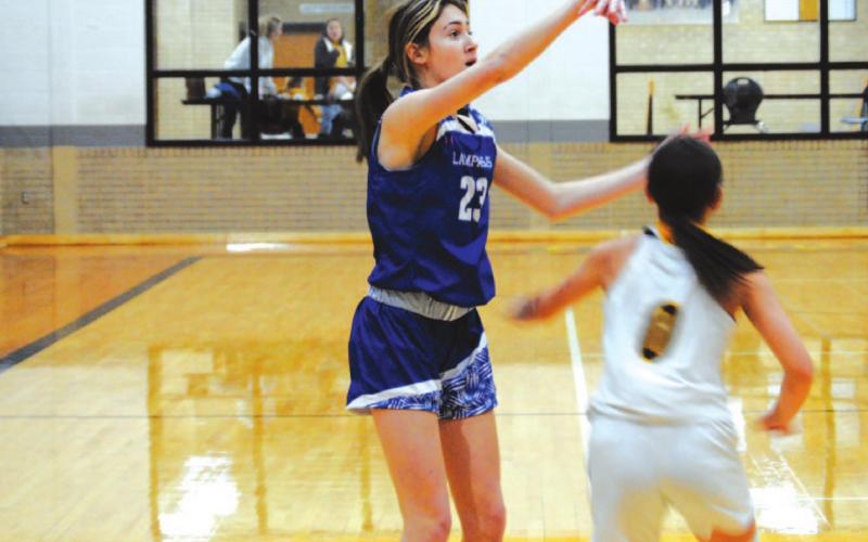 Payton Tatum rises up over a Gatesville defender for a three-point shot in the Lady Badgers’ win last Friday. HUNTER KING | DISPATCH RECORD