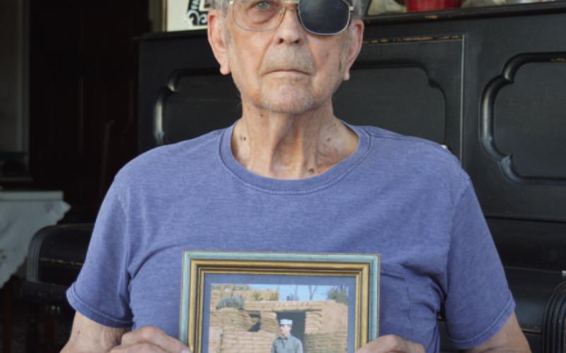 Marine Corps veteran James Welch displays a photo of himself from his younger years in the service outside a bunker. ERICK MITCHELL | DISPATCH RECORD