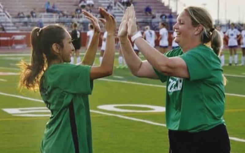 Burnside high-fives a former player with the Lady Bulldogs. COURTESY PHOTO