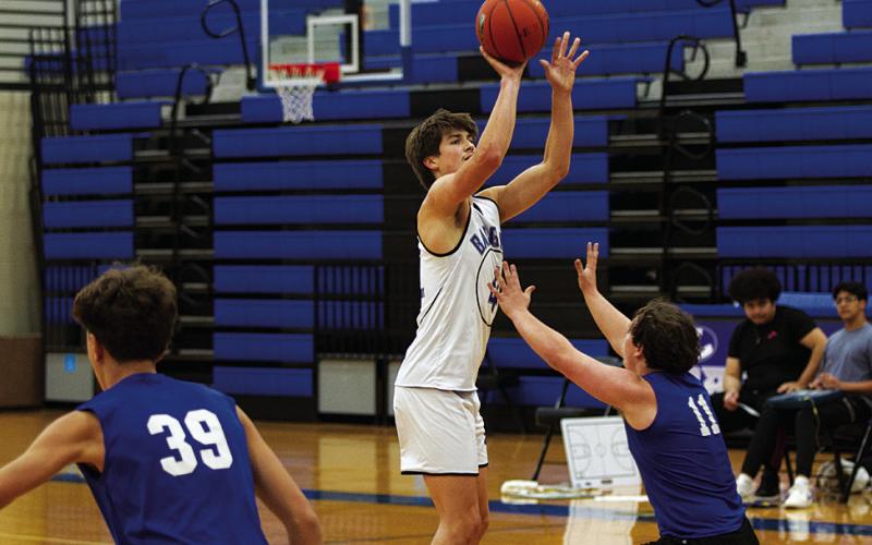 HUNTER KING | DISPATCH RECORD Calum Mitchell shoots a three-point shot during a recent practice. Basketball season is officially underway.