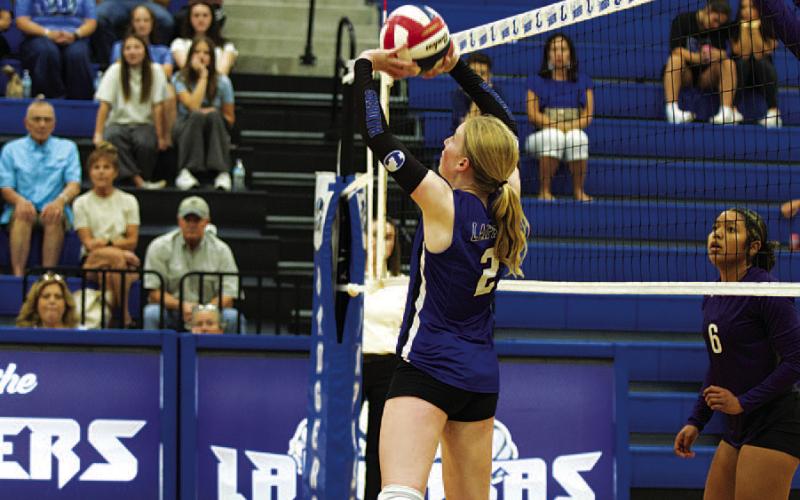 Ellie Felkner sets the ball up for a spike during the match against Florence. HUNTER KING | DISPATCH RECORD