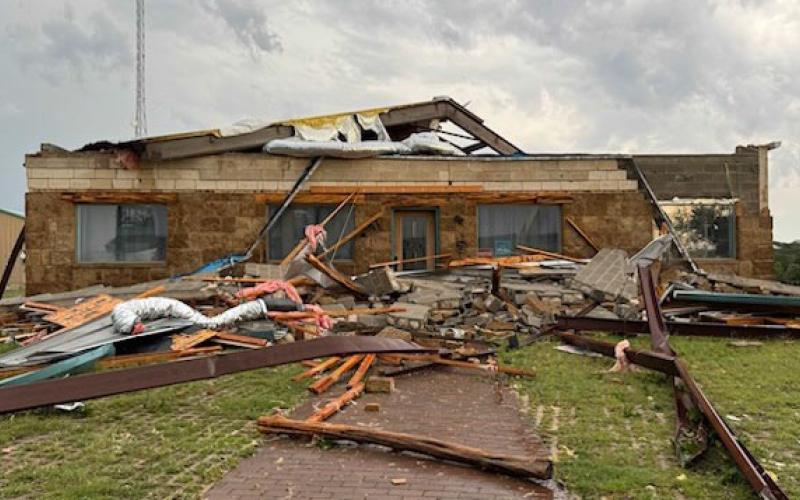 COURTESY PHOT| FACEBOOK Wooden beams and debris are scattered across the lawn, but this front office and back workshop in the Oakalla area escaped major damage from Thursday’s storm.