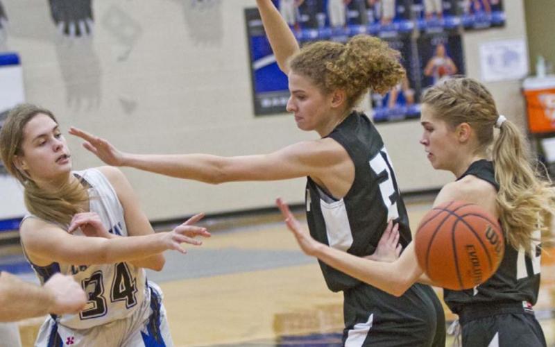 Jamie Ball passes the ball around two Waco Live Oak Classical defenders. JEFF LOWE | DISPATCH RECORD