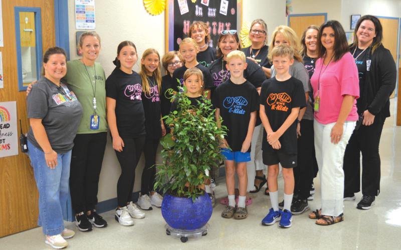 erick mitchell | dispatch record Fifth-grade Kline Whitis Elementary School students presented a tree last week to Hanna Springs Elementary in remembrance of former school nurse Tobi King.