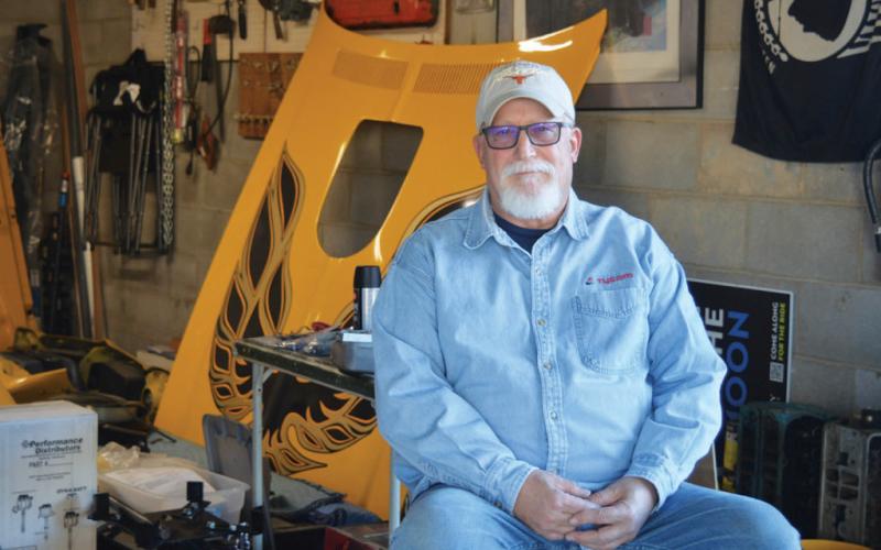 erick mitchell | dispatch record Lampasas resident Howard Tucker takes a seat outside his garage as the hood of the 1976 Pontiac Trans Am he is restoring rests in the background. Tucker, an engineer by trade, has a passion for classic automobiles.