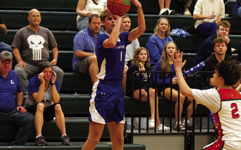 Vincent Shahan shoots a three-point shot in the district opener. HUNTER KING | DISPATCH RECORD