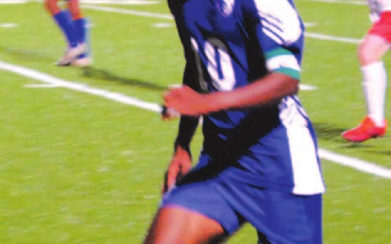 KJ Stephens chases a ball down the sideline on his way toward the goal in last Friday’s match. HUNTER KING | DISPATCH RECORD