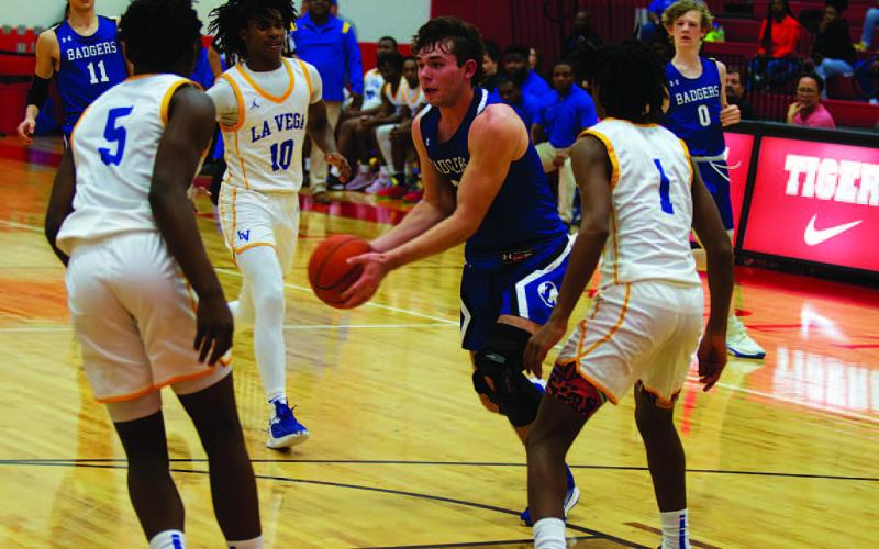 HUNTER KING | DISPATCH RECORD Carter Johnson drives between the Pirates before passing to a teammate.