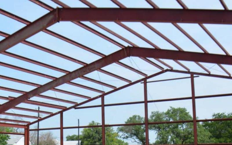Red steel trusses for the 10,000-square-foot building that will become the new Lampasas Community Church can be seen at its location on East Fourth Street. Monique brand | dispatch record