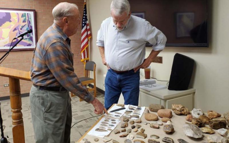 Former mayor Jack Calvert, left, and Lampasas County Historical Commission member Boyce Cabaniss talk about artifacts Cabaniss has unearthed across the area. The historian offered a special presentation last week at the library. LENORA ISENHOUR | COURTESY PHOTO
