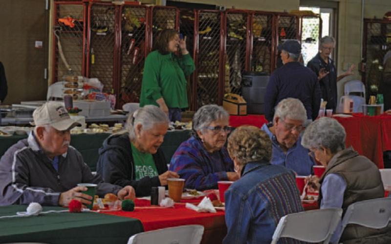 Lampasas County residents enjoy their meal during the Lampasas Volunteer Fire Department’s holiday lunch and toy drive on Monday. ERICK MITCHELL |DISPATCH RECORD