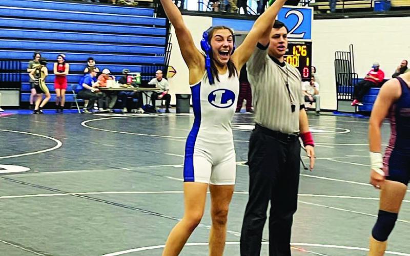 COURTESY PHOTO | LHS WRESTLING TWITTER Charlie Freese celebrates her match win at the district competition last week.