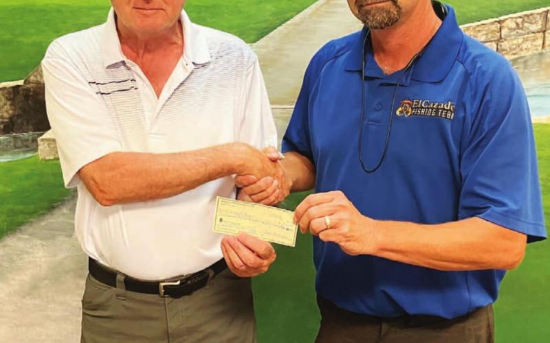 Dwight Oyer, left, and Chad Hamann pose with a check for the hole-in-one Oyer hit on hole No. 6 Monday. COURTESY PHOTO