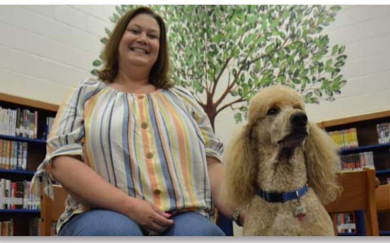 Taylor Creek Elementary School Principal Renee Cummings is retiring after 26 years in the education field. She is pictured with another Lampasas Independent School District retiree: Tayt, the campus dog for Taylor Creek. MONIQUE BRAND | DISPATCH RECORD