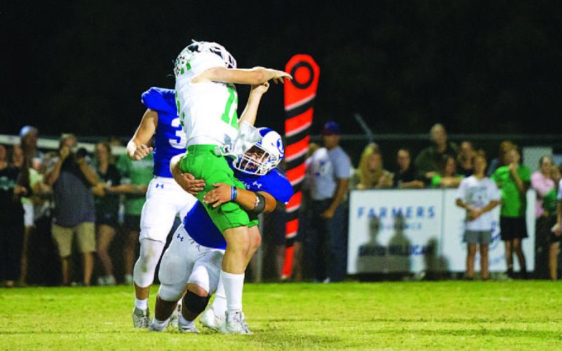 Levi Rivera puts a hit on the Burnet quarterback during last week’s district opener. HUNTER KING | DISPATCH RECORD