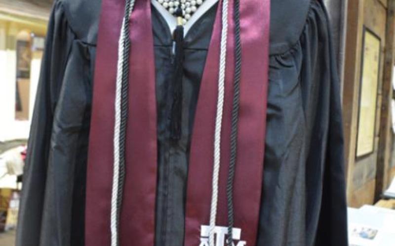 A graduation cap and gown of an A&amp;amp;M graduate are on display. MONIQUE BRAND | DISPATCH RECORD