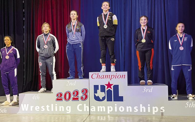 COURTESY PHOTO | LHS WRESTLING TWITTER Charlie Freese, right, stands on the podium in fifth place at the UIL state wrestling championship.