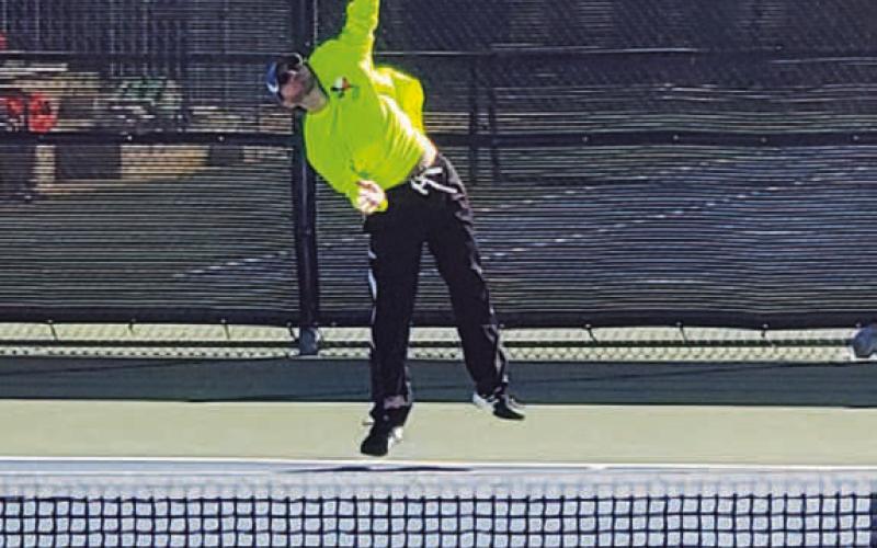 COURTESY PHOTO | LAINA WHITE Eric White follows through on a serve during a match.
