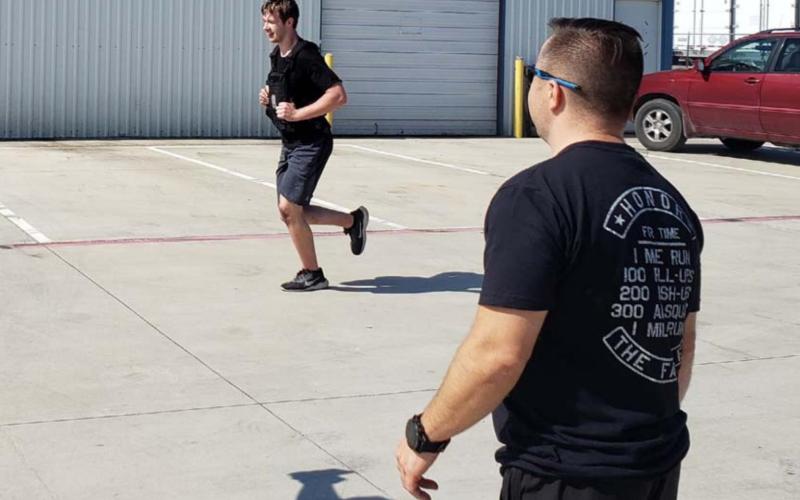 Matt Patrick, coach and owner of the former CrossFit Vector, encourages an athlete on his final run of the 2021 Murph Challenge. ALEXANDRIA RANDOLPH | DISPATCH RECORD