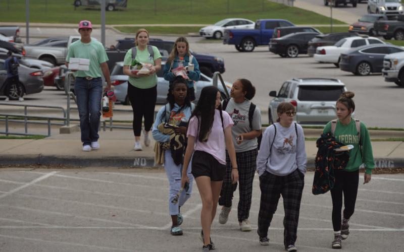 ERICK MITCHELL | DISPATCH RECORD Lampasas High School students make their way to campus Thursday on the final day of school.