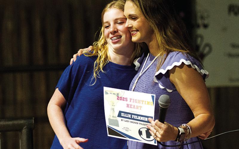 HUNTER KING | DISPATCH RECORD Ellie Felkner hugs Ali Tippie as she receives the Fighting Heart Award.