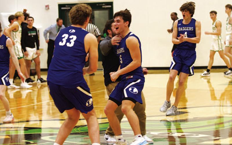 Beau Patterson (33), Trent Seneca (5) and the Badger team celebrate after beating Burnet on the road on Tuesday night. HUNTER KING | DISPATCH RECORD