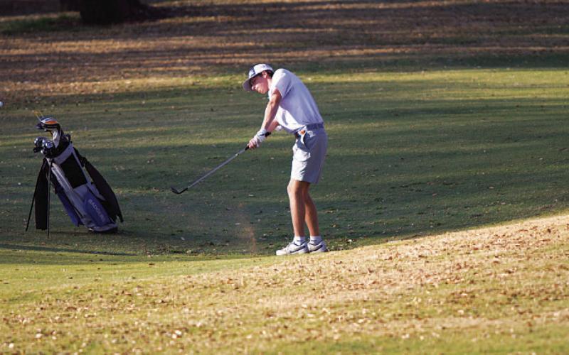 Bryson Hammond hits a pitch shot on hole 18 during the district tournament. HUNTER KING | DISPATCH RECORD