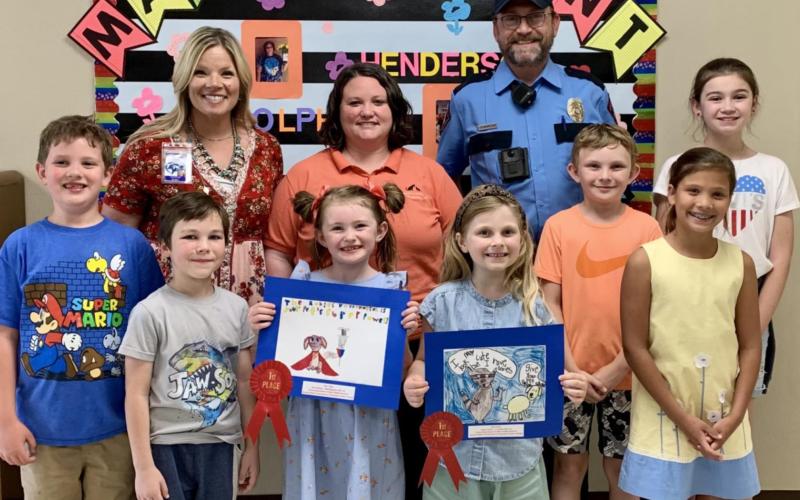Honored for their participation in the annual Rabies Awareness &amp;amp; Prevention Poster Contest were these Kline Whitis Elementary students: from left, Greyson Moore, Parker Mosebar, Kylee Davis, Ava Latham, Jeb Patterson, Sadie Walker and Hallie Watson. Pictured with them are Principal Leanne Bobo, back row at left, Animal Control Officer Kasey Schwartzer and Animal Control Officer Joseph Schwartzer. COURTESY PHOTO