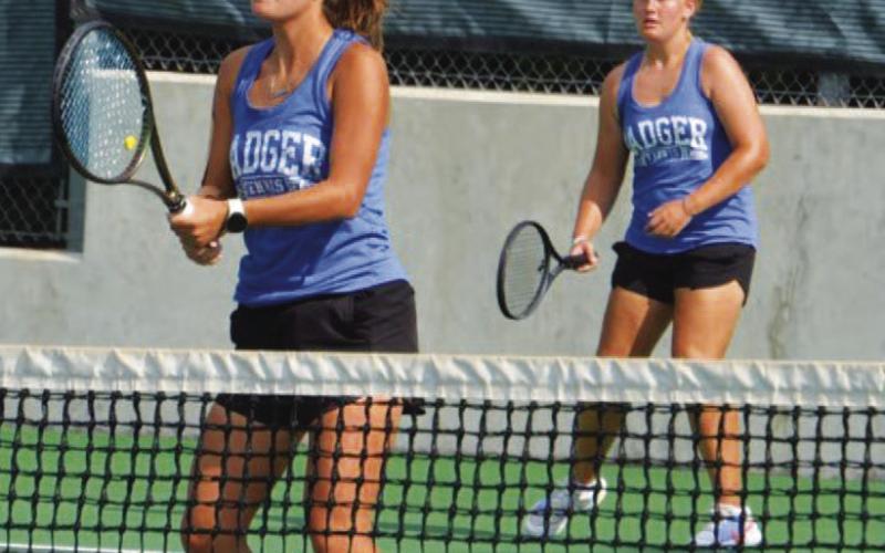Caroline White, front, and Sydney Unger await a serve during their doubles match against Leander last week. COURTESY PHOTO | KENNETH PEISER